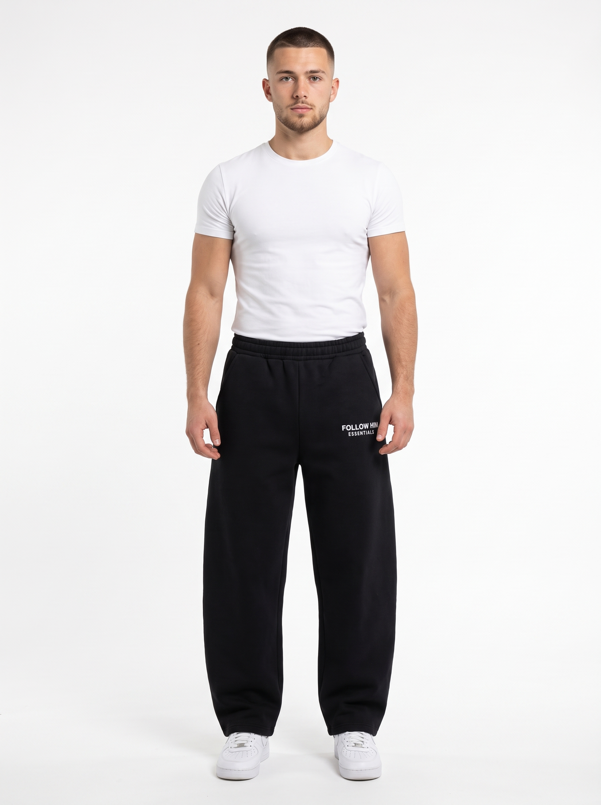 Man wearing black barrel leg sweatpants