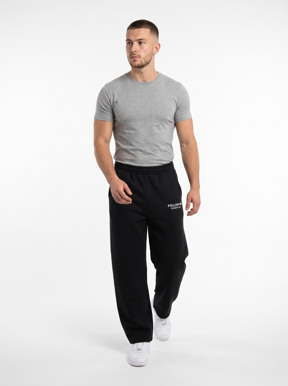 Man walking in black barrel leg sweatpants