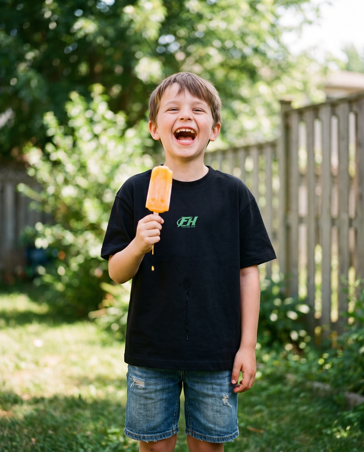 Boy laughing in the Youth DOOMED tee