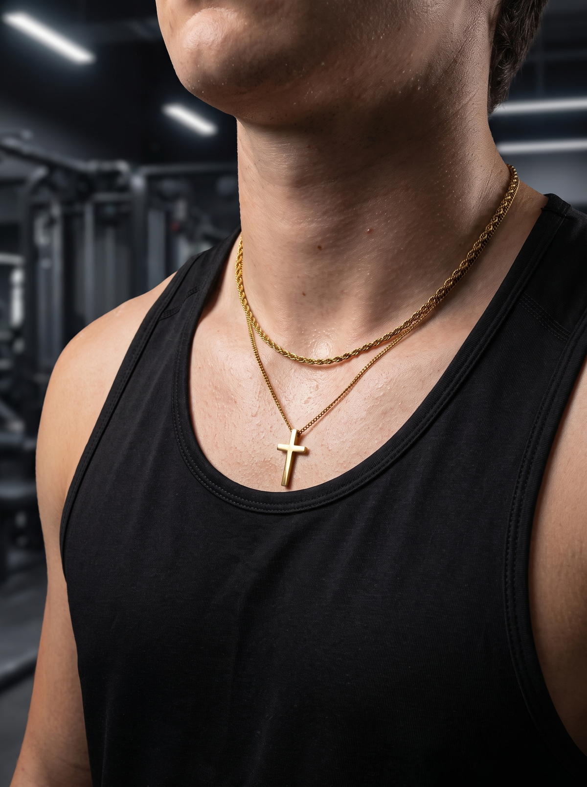 Gold cross necklace and rope chain worn in the gym