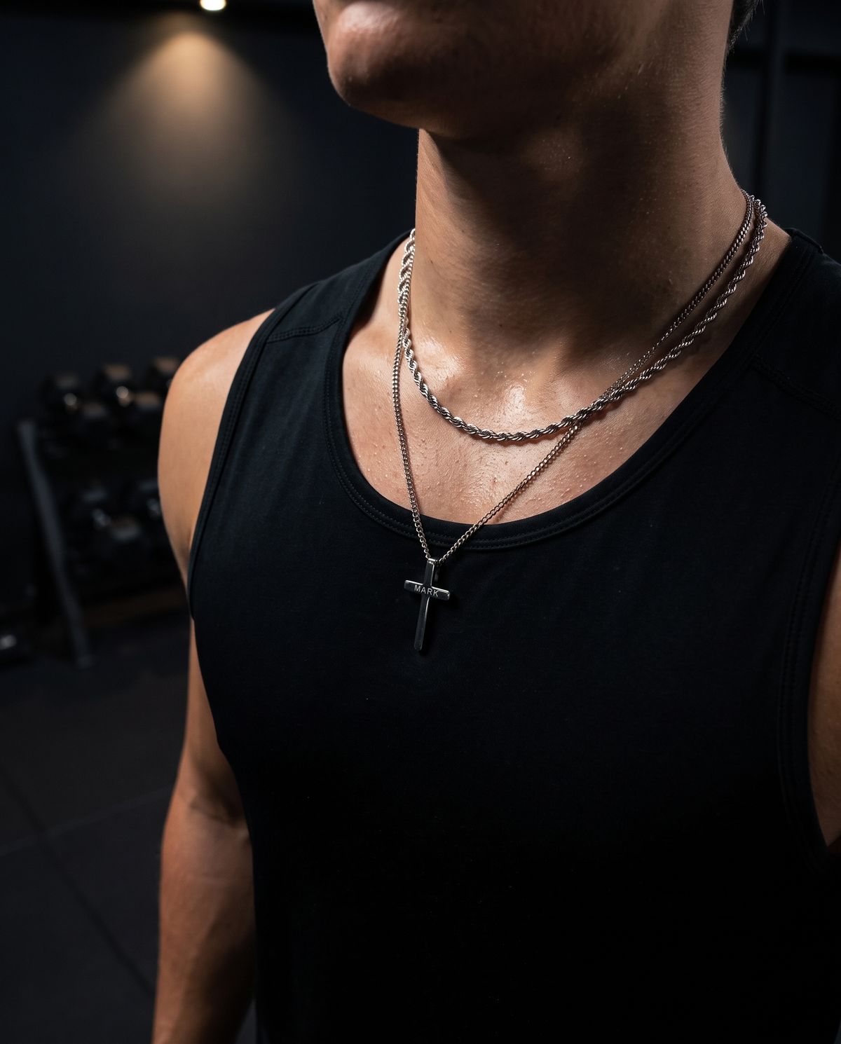 Silver rope chain and cross necklace at the gym