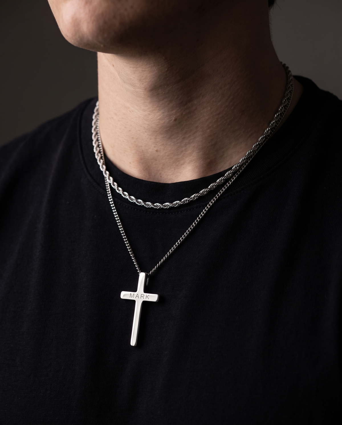 Silver cross necklace and rope chain worn